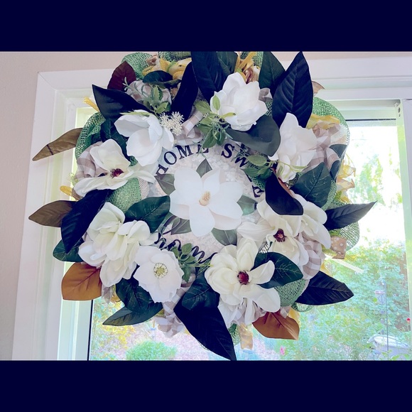 Magnolia Wreath: Jute deco mesh with ribbons tubing and magnolia flowers.